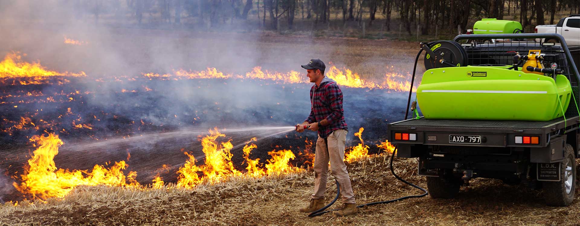 man puts out the bushfire with water